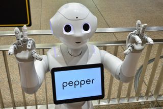 Pepper the robot with hands up