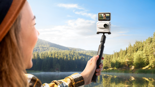 Insta360 Go 3 camera in modular case with selfie screen in action