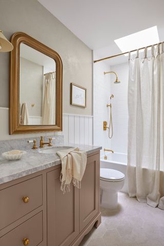 Neutral bathroom by Adrian Dagli of IW Studio with lilac vanity