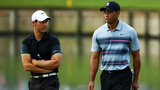 Tiger Woods talks to his coach Chris Como (L) during a practice round for THE PLAYERS Championship at the TPC Sawgrass Stadium course on May 6, 2015
