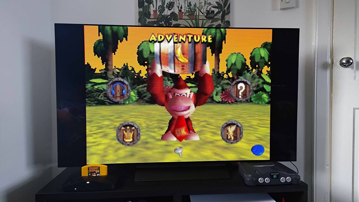 Analogue 3D connected to LG OLED C4 TV with Donkey Kong 64 title screen displayed.