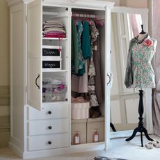 dressing room with white wardrobe and mannequin
