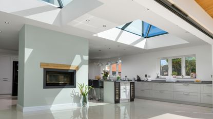Korniche bifold doors and roof lantern lifestyle imagery open plan white apartment with views 