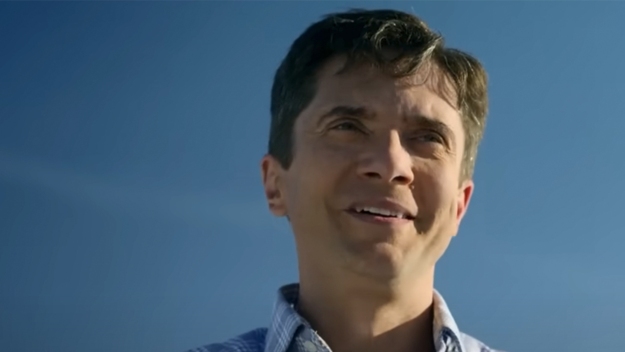 A closeup of Topher Grace looking nervous, but kind of smiling in The Waterfront.