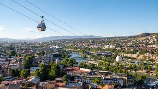 A cable cart is pictured travelling across Tbilisi