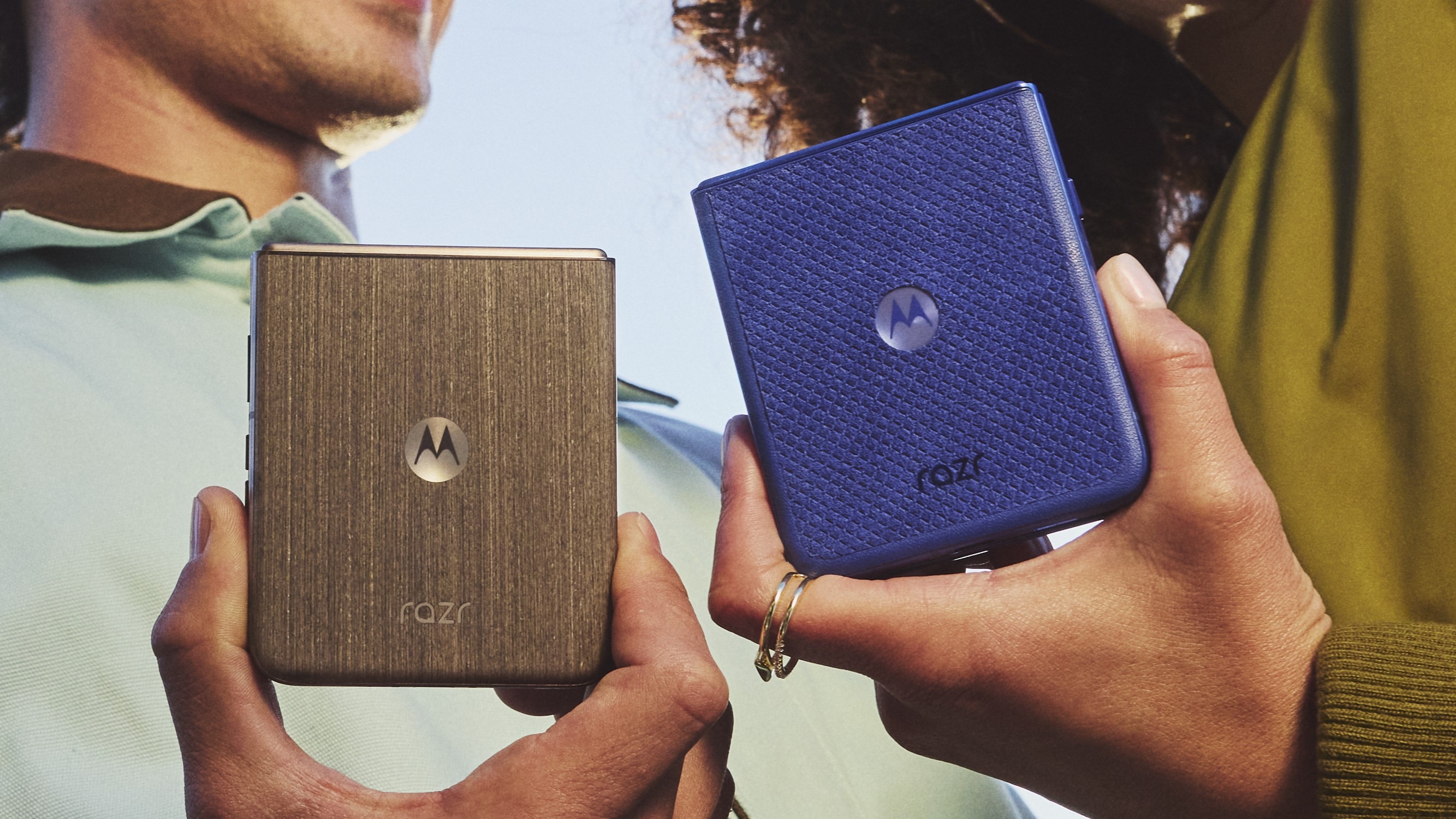 Two people holding the Motorola Razr Ultra 2026 in its two available colors