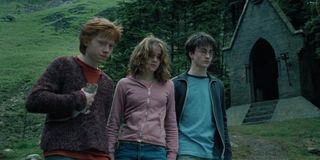 Daniel Radcliff, Emma Watson, and Rupert Grint looking on in Harry Potter and the Prisoner of Azkaba