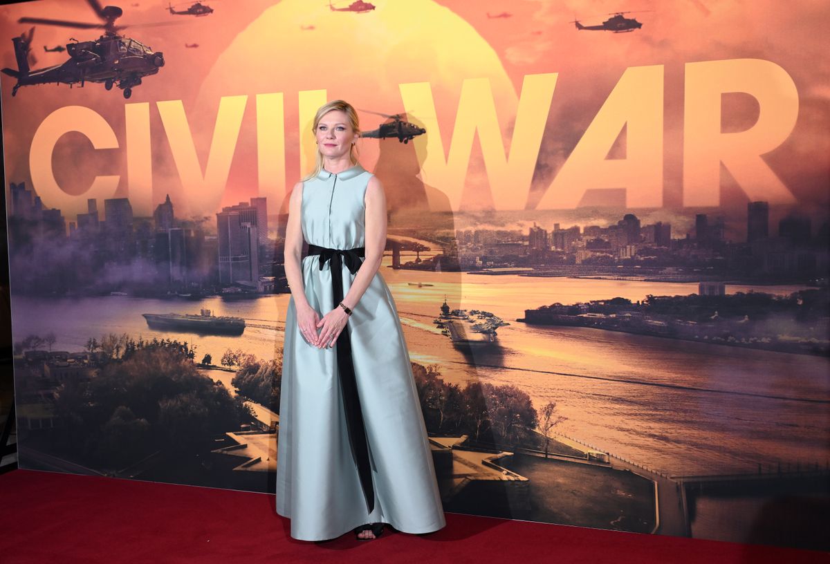 Kirstin Dunst stood in front of Civil War poster