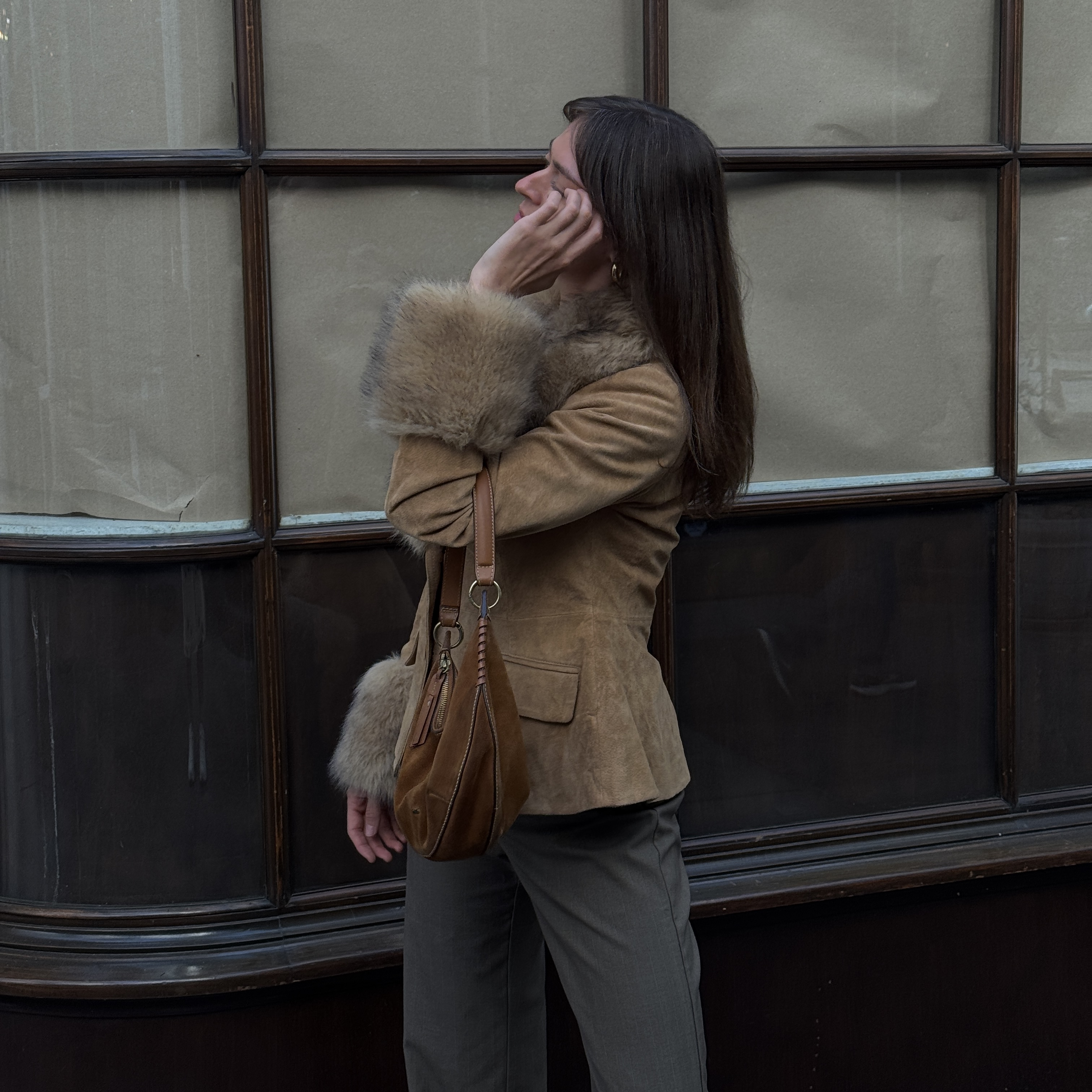 Kathryn Zahorak models a fur trim jacket, green pants, and suede bag