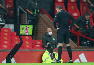 Referee David Coote consults the VAR