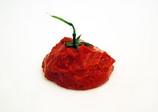 Red paste shaped like a tomato with a green tomato stem on top