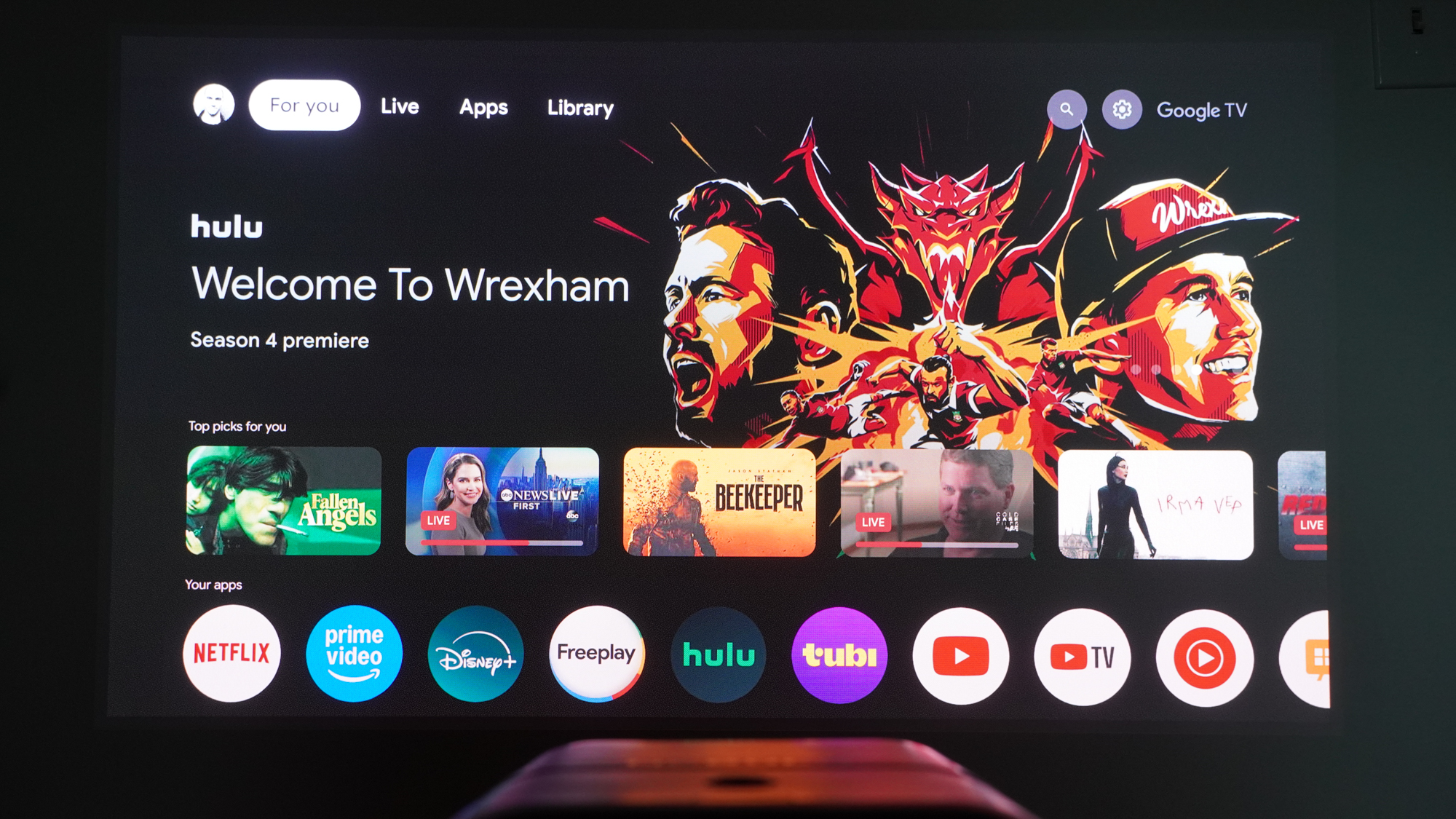 Google TV interface projected onto a wall by the Anker Nebula X1 projector.