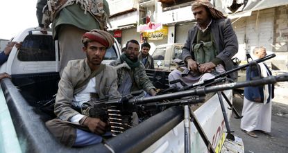 Huthi rebels in front of the residence of Yemen's former president Ali Abdullah Saleh in Sanaa. 