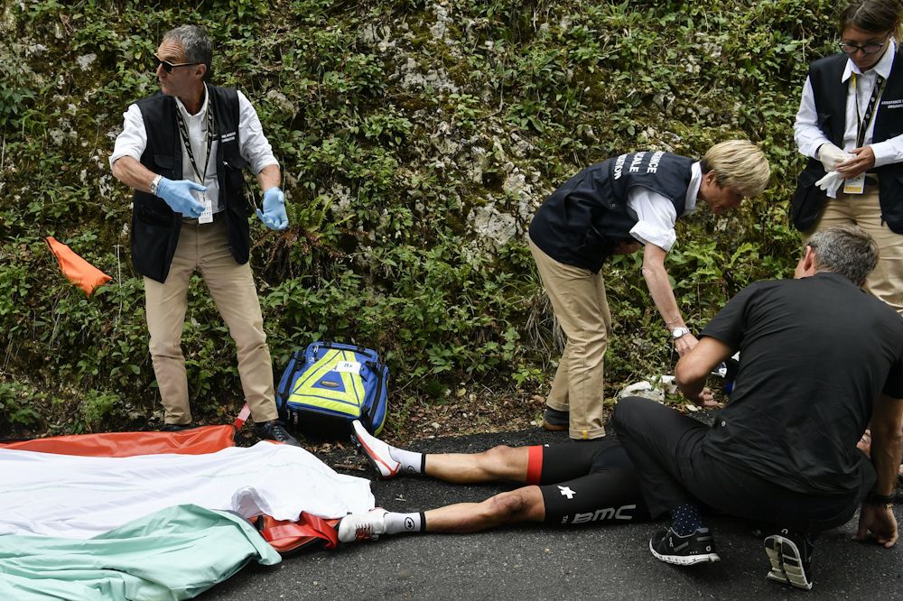 Richie Porte is attended by medical staff after crashing during stage 9 at the Tour de France