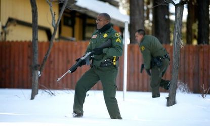 San Bernadino County sheriffs search a home for former Los Angeles cop Christopher Doner on Feb. 10.