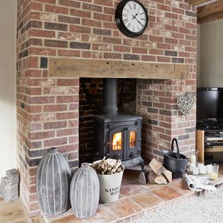 exposed brick fireplace with woodburning stove
