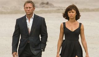 Quantum of Solace Daniel Craig and Olga Kurylenko walking through the desert