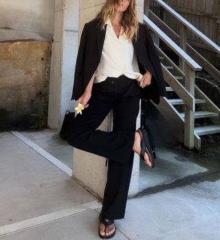 @angiesmithstyle wearing FitFlop thong sandals with a suit