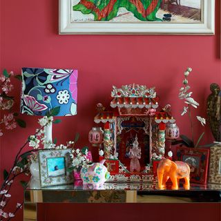 pink wall with kitsch souvenirs and showpieces