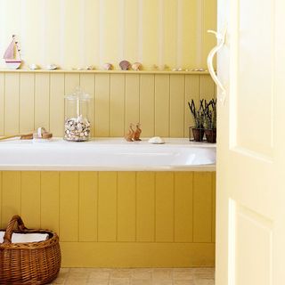 Yellow bathroom with bathtub
