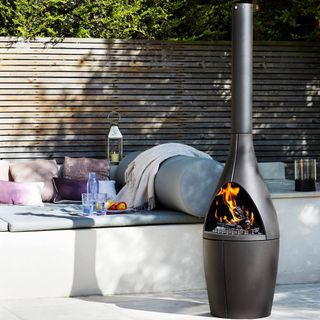 Contemporary outdoor woodburning stove on a patio