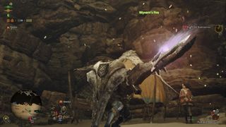 A Hunter in Monster Hunter Wilds using the Gunlance, the weapon is just starting to light up as if it's about to fire.