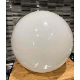 white glass globe light on background
