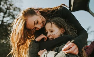 Mother hugging daughter