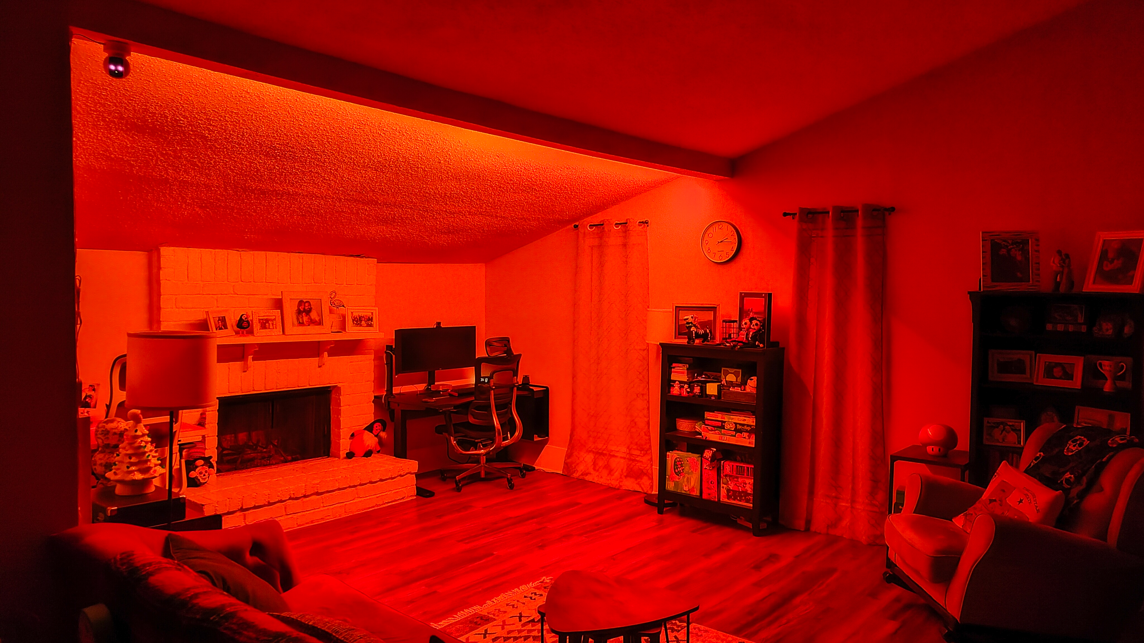 The Govee Strip Light with Skyline Kit lighting a room red with Halloween decorations in the background