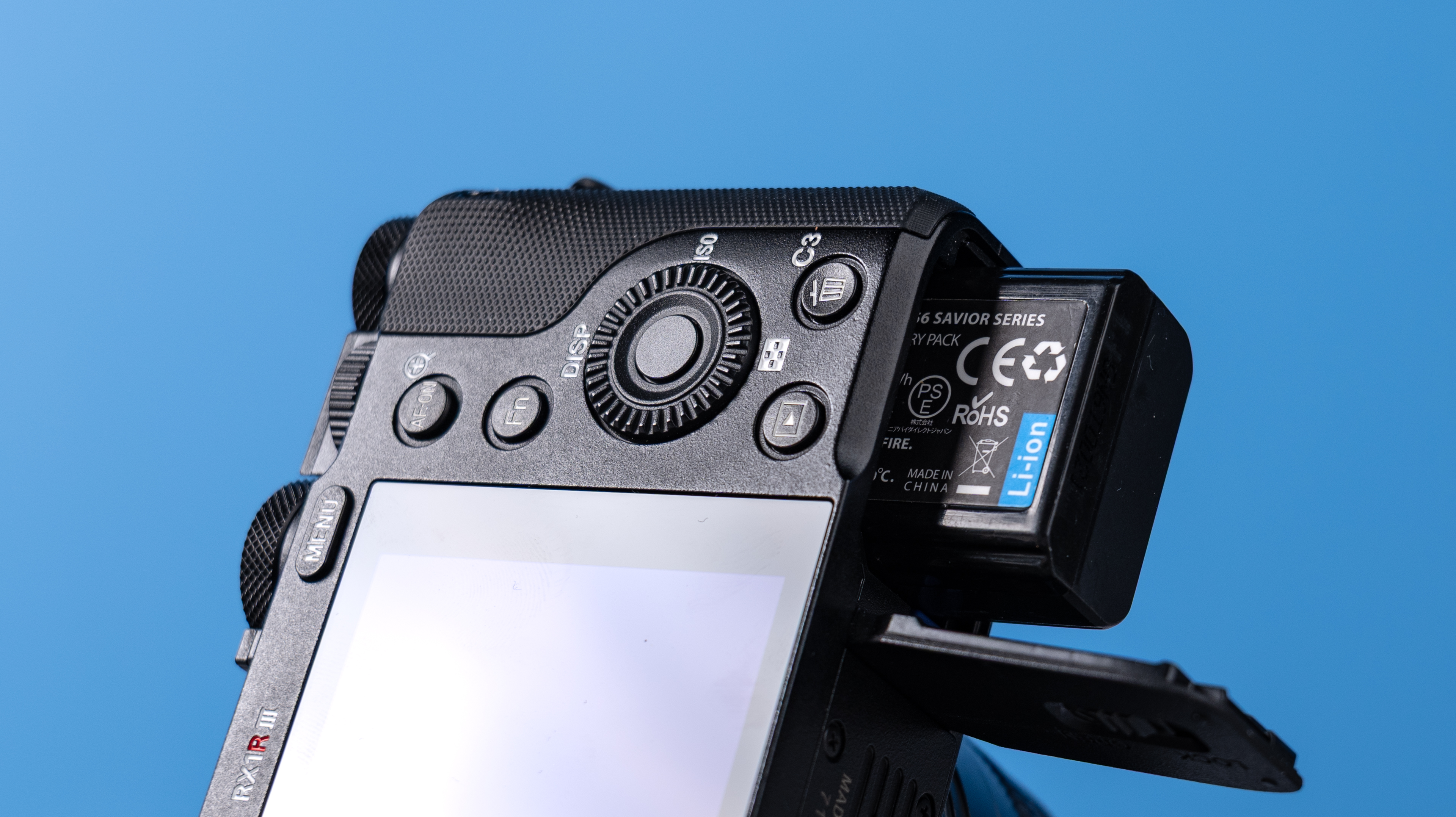 A photo of the Sony RX1R III with its battery half out the compartment