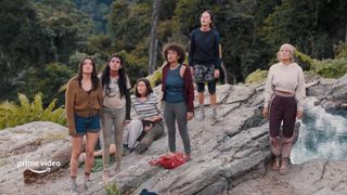 a group of girls standing on a mountain in the tv show the wilds