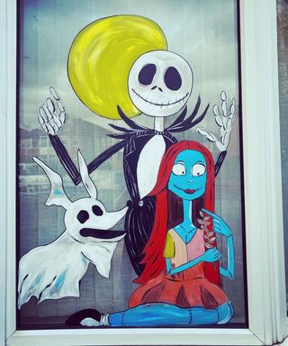 Halloween window ideas with painted Nightmare before Christmas scene