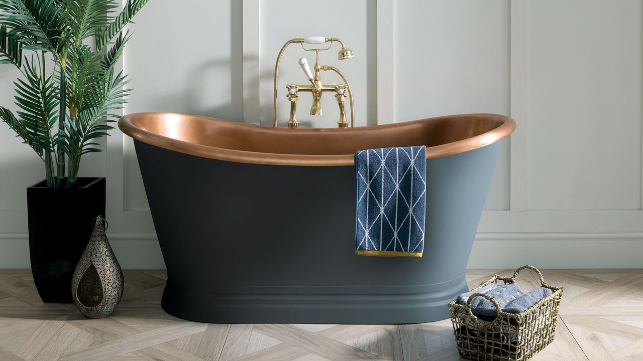 white wall with bathtub and potted plants