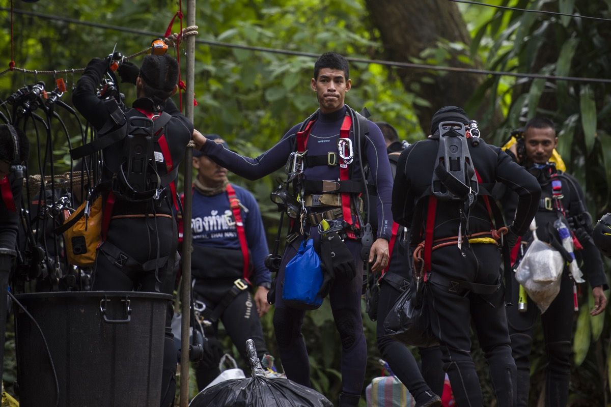 Thai divers carry supplies as rescue operations continue for 12 boys and their coach trapped at Tham Luang cave on July 5, 2018.