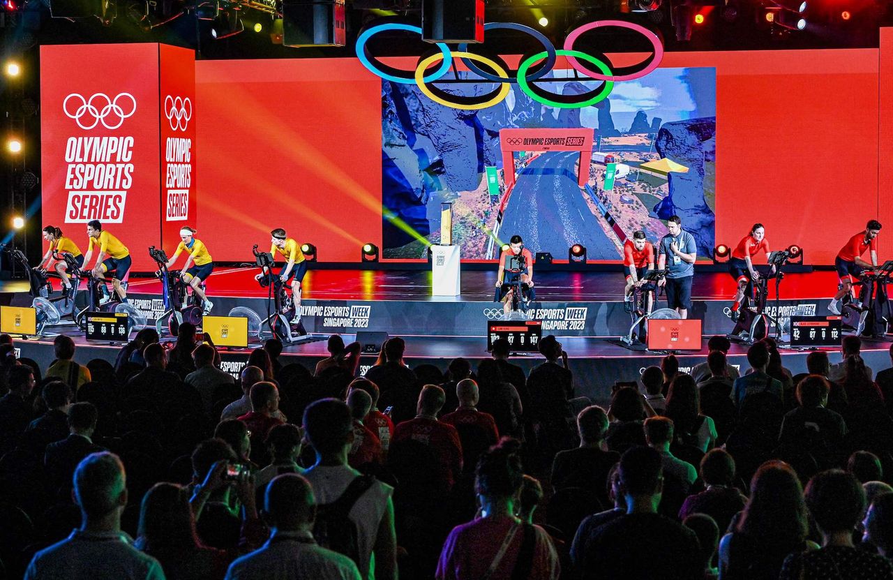 Spectators watch the stage as competitors take part in a cycling event during the Olympic Esports Week in Singapore on June 23, 2023. (Photo by Roslan RAHMAN / AFP) (Photo by ROSLAN RAHMAN/AFP via Getty Images)