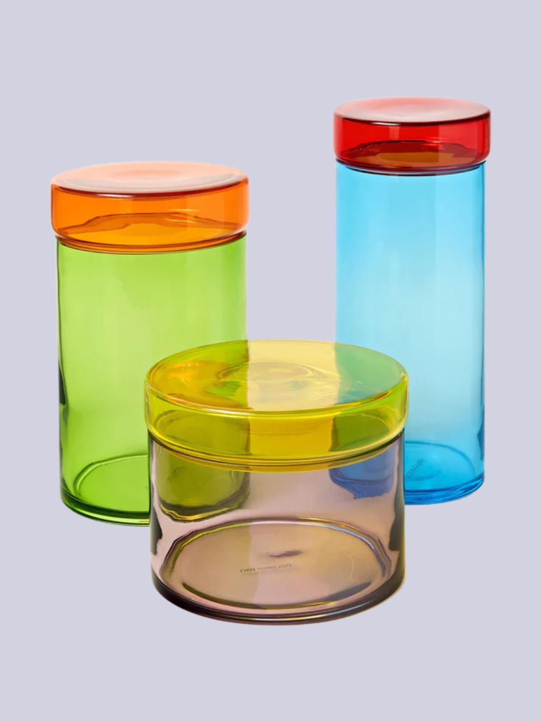 A set of three multi-colored glass storage jars