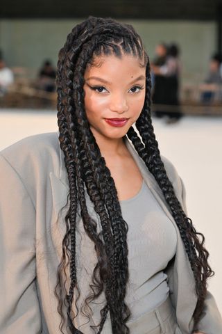 Halle Bailey with various length braids in her hair.
