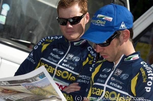 Vacansoleil riders check the papers before the start