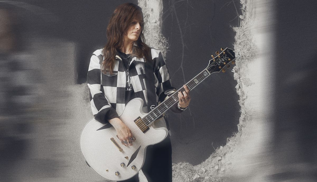 Emily Wolfe holds her new signature &quot;White Wolfe&quot; Epiphone Sheraton model