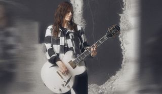 Emily Wolfe holds her new signature "White Wolfe" Epiphone Sheraton model