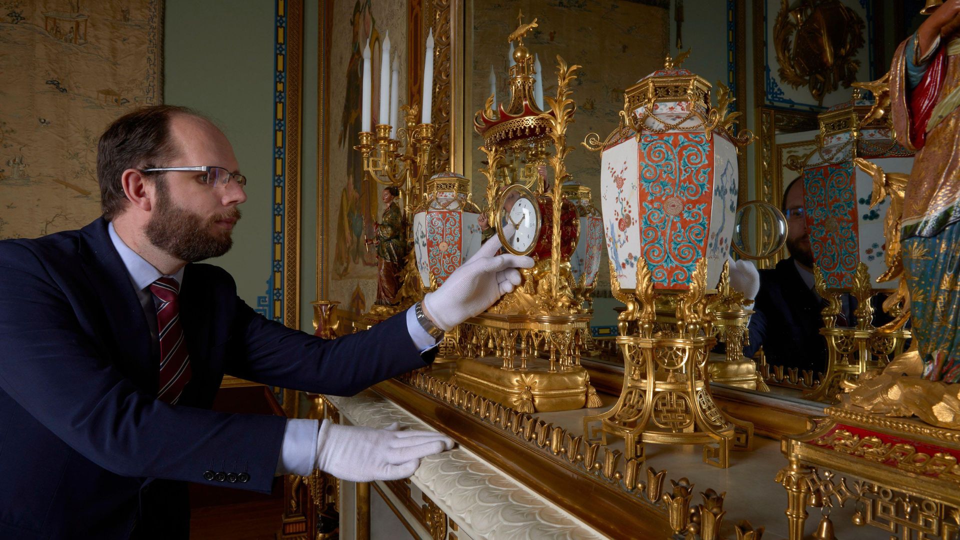 A horologist tending to the clocks in Buckingham Palace