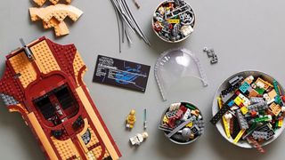 Lego Luke Skywalker's Landspeeder on a gray table, in the process of being built