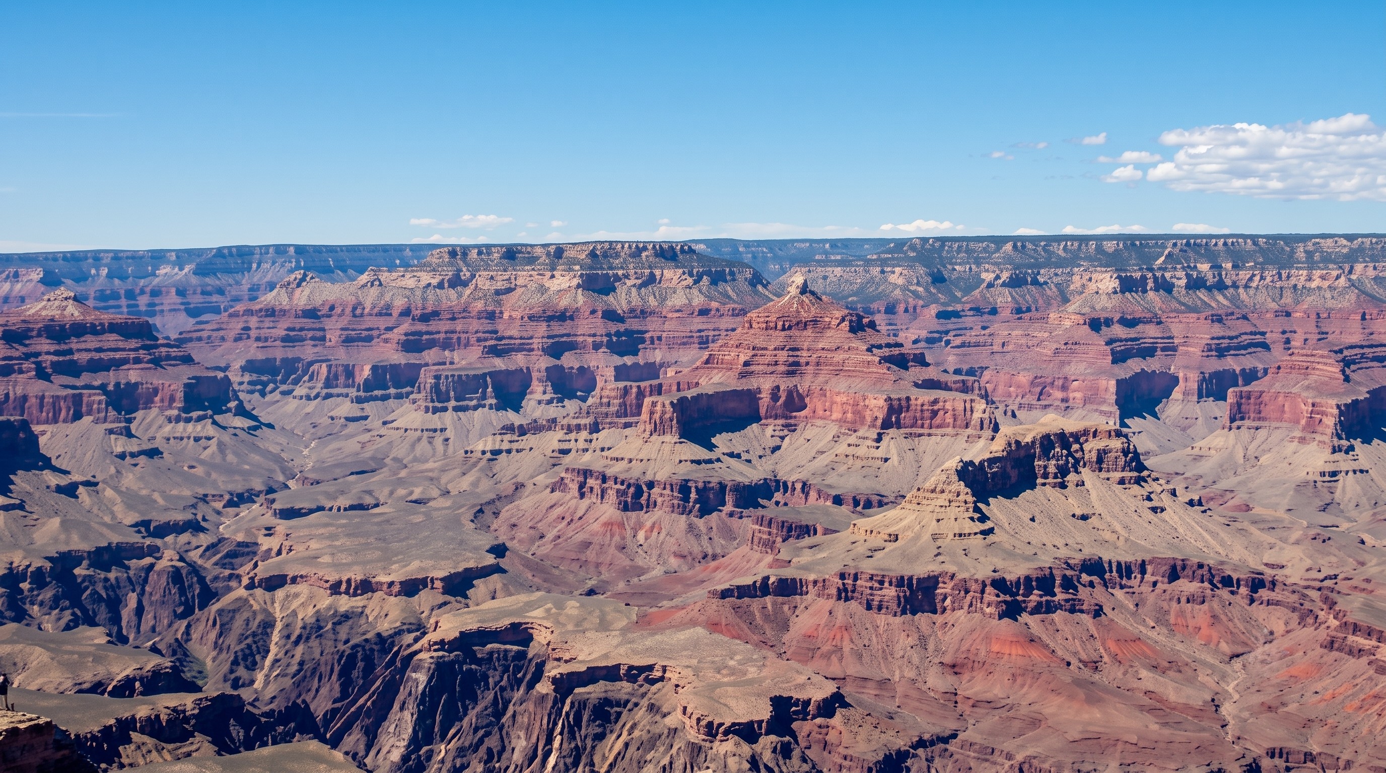 A photo of the Grand Canyon showing the landscape, rocks, and blue sky