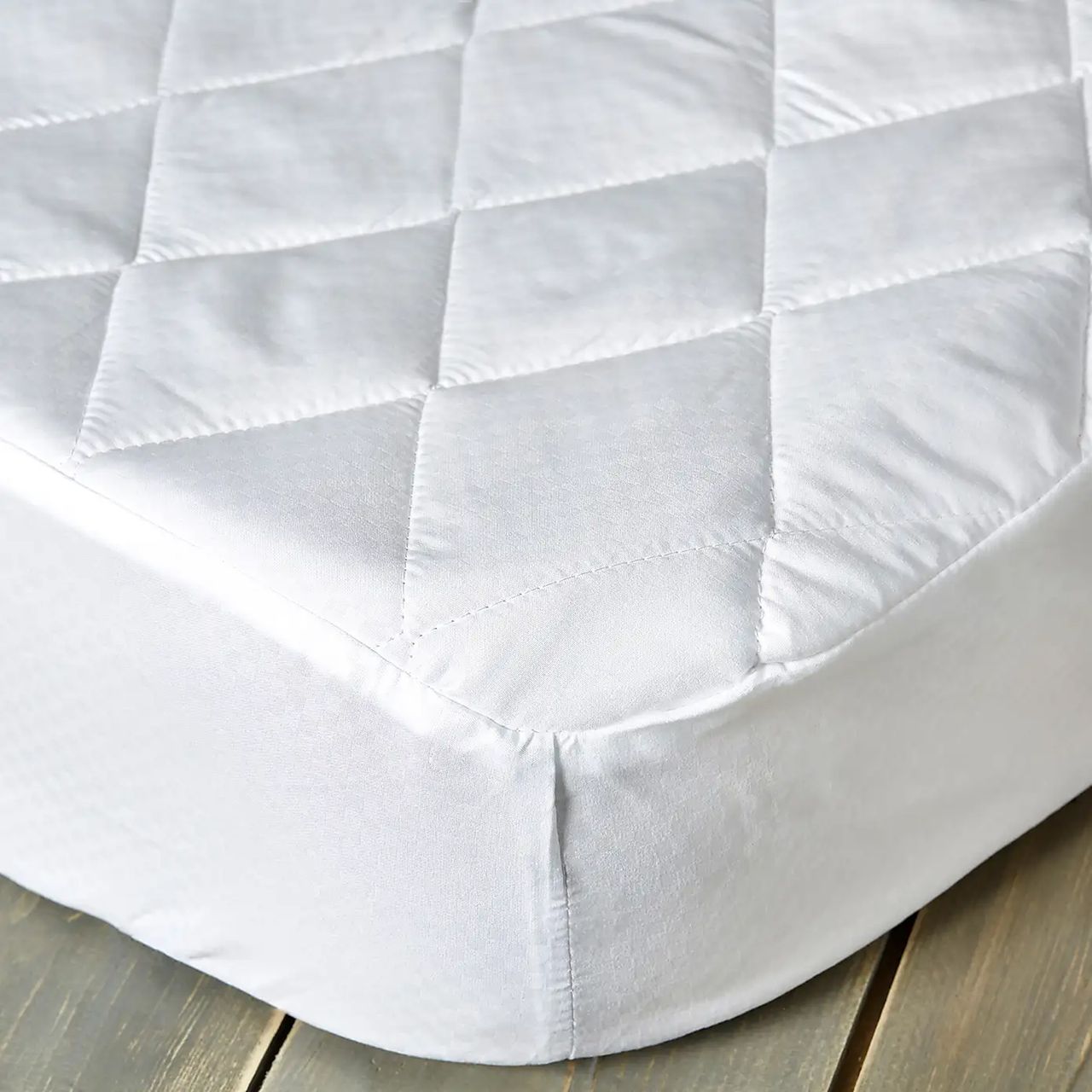 Dunelm Fogarty Soft Touch Mattress Protector with a diamond pattern on top.