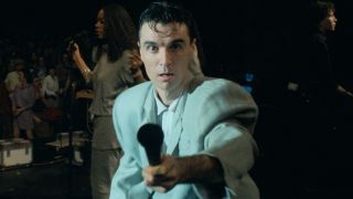 Lynn Mobray sings as David Byrne holds the mic to the camera in Stop Making Sense.