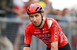 Amaury Capiot crosses the finish line injured after being involved in a crash during stage 14 at the Tour de France