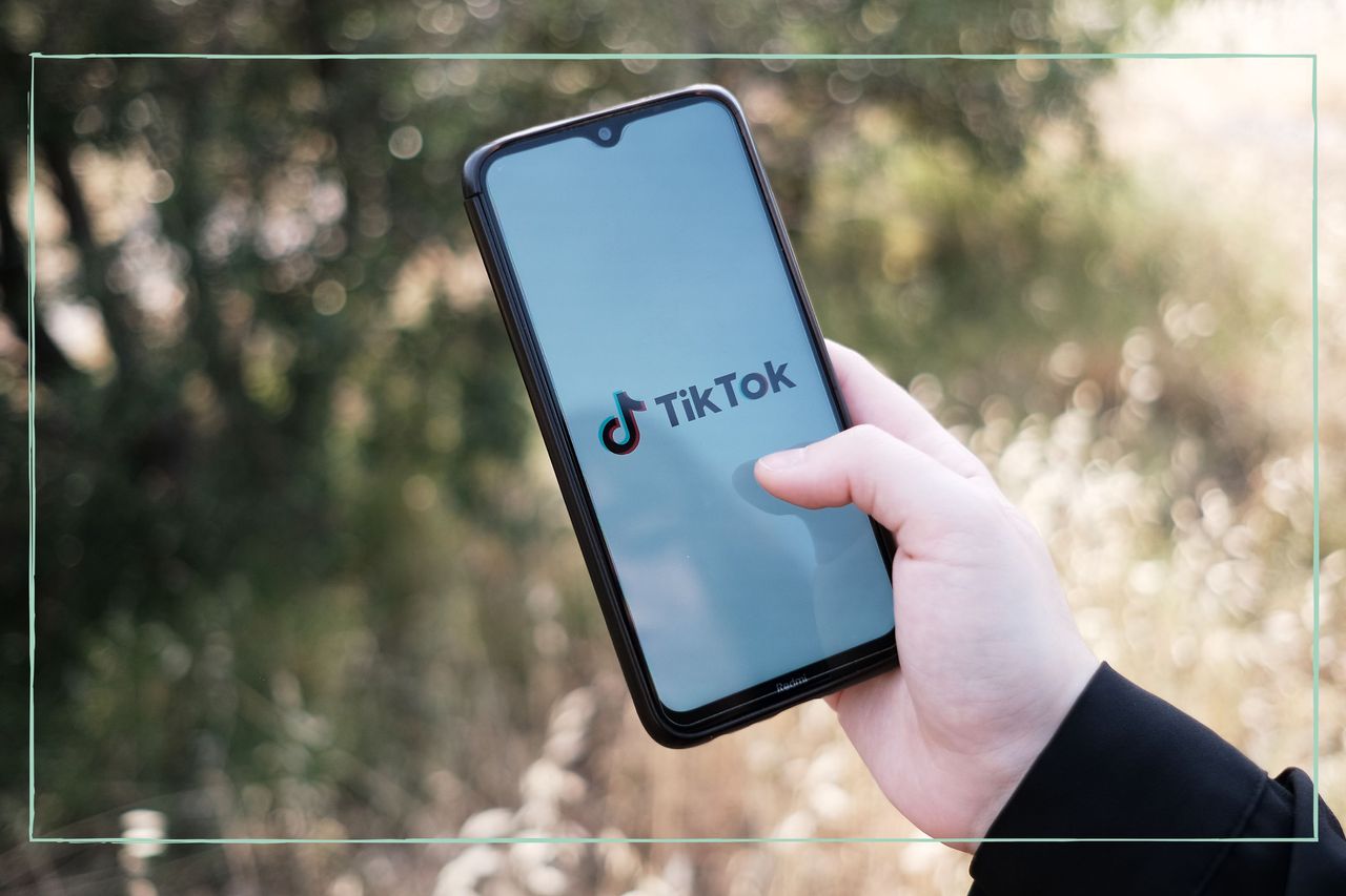 A close up of a phone displaying the TikTok logo