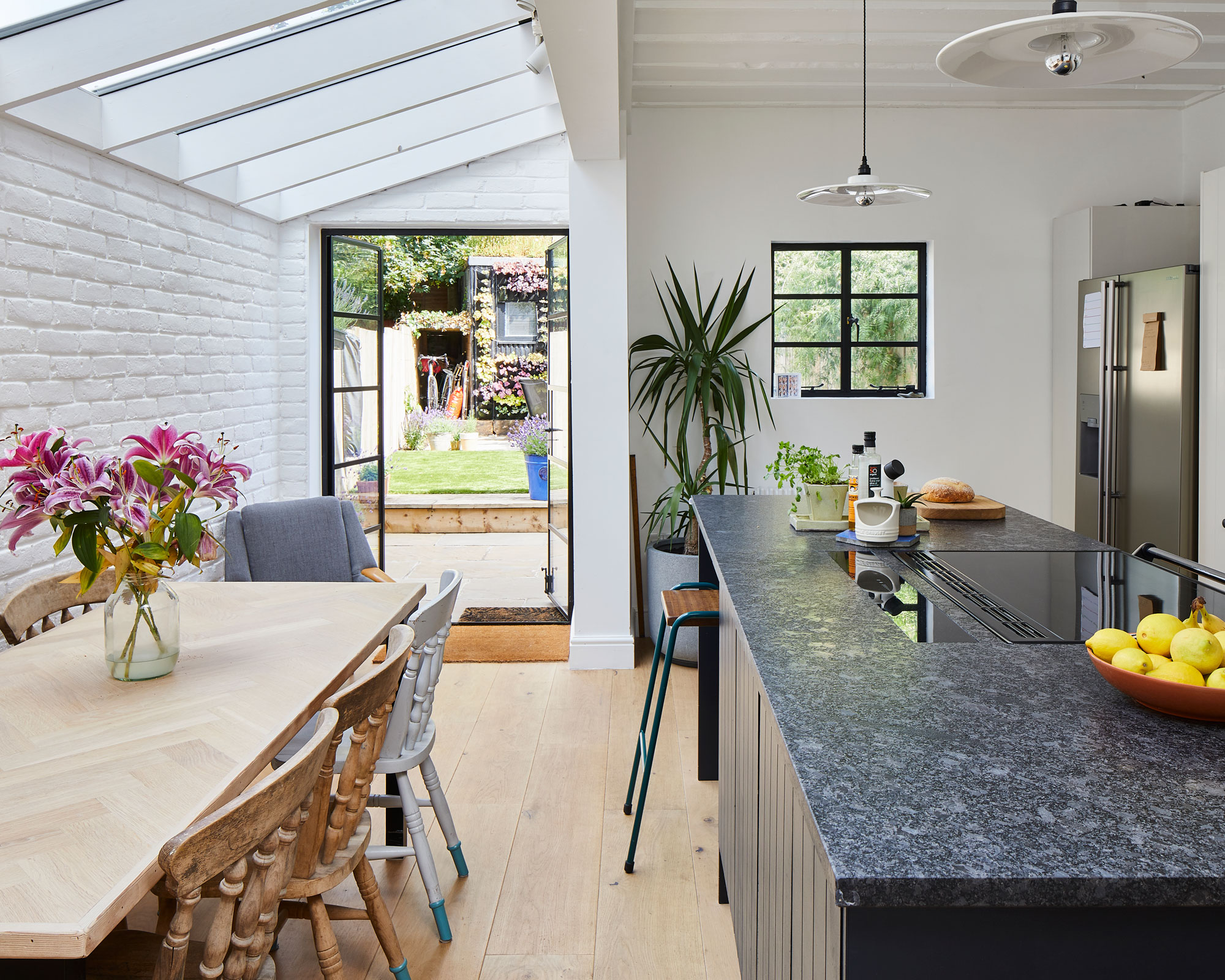 kitchen with marble worktop and wooden dining set