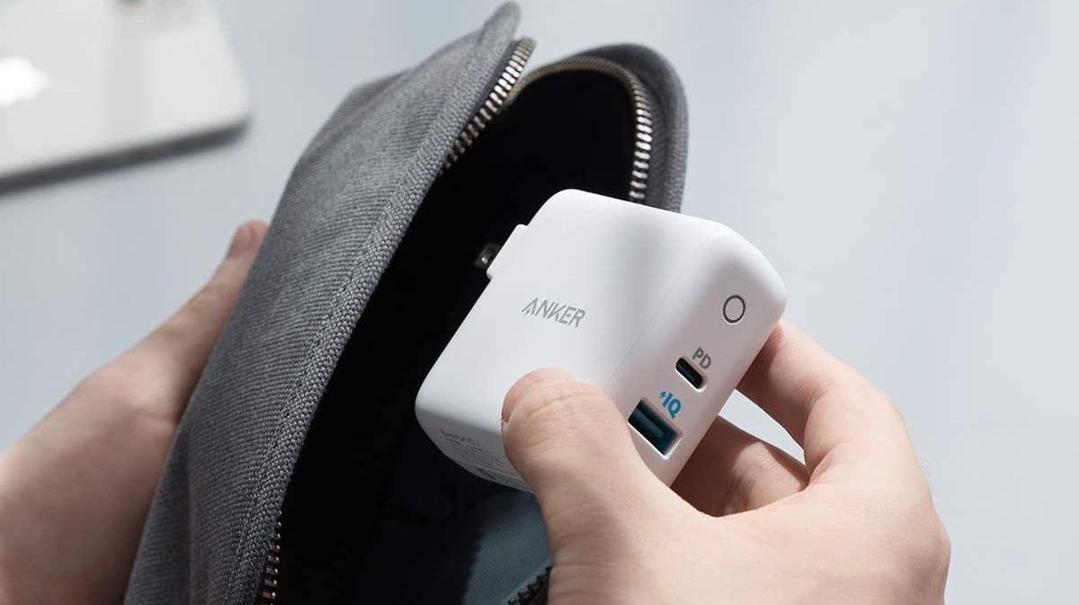 An Anker PowerPort PD 2 being put in a bag