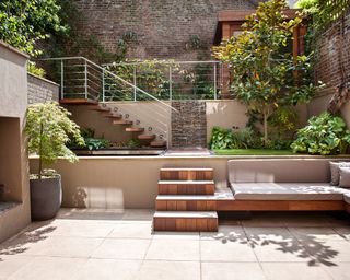 modern tiered courtyard garden with contemporary metal railings on the garden walls